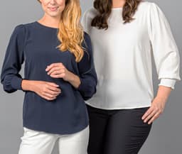 A navy blue top with shirred cuffs alongside a white top, both with a loose fit and round necklines.