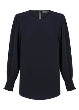 A navy blouse with a round neckline, long shirred cuffs, and subtle puffed sleeves. It features a keyhole opening at the back and a logo.