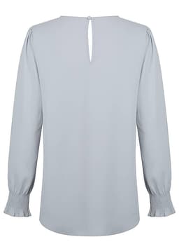 A light grey blouse with long shirred cuffs and a back keyhole detail. It has a simple, elegant design.