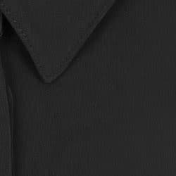 A black half-placket shirt featuring a collared neckline and textured fabric. It includes branding.