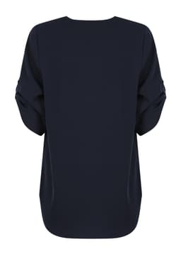 A navy blue Reese V Neck shirt with a loose fit and rolled sleeves, featuring a logo on the back.