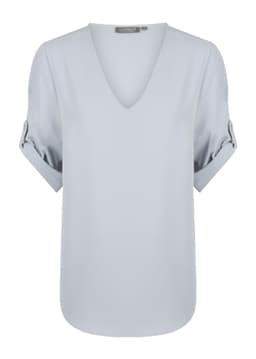 A light blue V-neck shirt with rolled sleeves and a smooth finish. It features a branding label at the neckline.