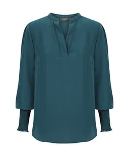 Teal long sleeve top with a V-neckline and gathered sleeve details. Features a branding logo.