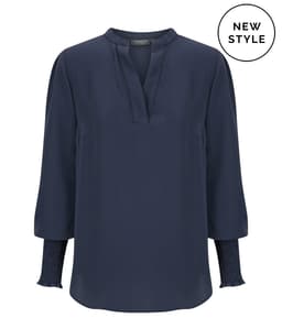 A navy long sleeve top featuring a V-neck and pleated sleeves, with a branding logo present.