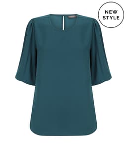 A teal puff sleeve top with a square neckline and a back keyhole detail, featuring a logo.