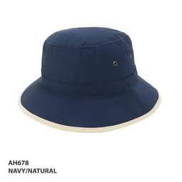 A navy and natural microfibre bucket trim hat featuring ventilation eyelets and a wide brim. Includes branding.