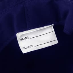 A navy blue bucket hat featuring a label for name and class identification. The hat has a branding logo.