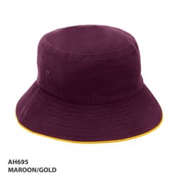 A maroon bucket hat with a gold trim and a logo on the side.