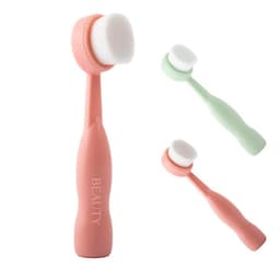 Three soft facial cleansing brushes in pink and green, featuring a smooth, round brush head and ergonomic handles. Each has a logo.