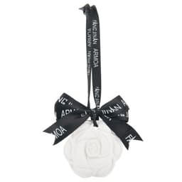 A white hanging gypsum aromatherapy tablet in the shape of a flower, secured with a black ribbon and bow.