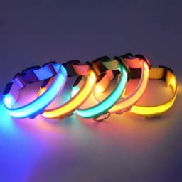 A collection of LED dog collars in various colours including blue, green, yellow, and orange, featuring a logo.