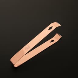 A pair of copper-finished ice tongs with a distinctive design and a logo on the side.