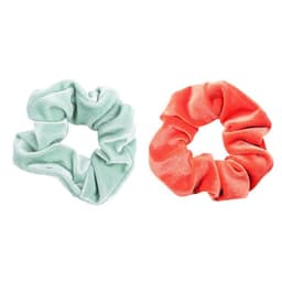 A green and an orange velvet hair scrunchie are displayed side by side, featuring a soft, textured fabric.