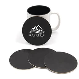 A set of four black absorbent paper coasters with a logo, alongside a white mug with a black interior.