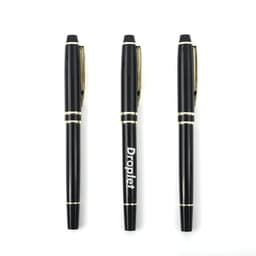 A set of three luxury custom stainless steel ballpoint pens in black with gold accents and a logo.