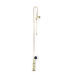 A custom metal engraved necklace featuring a gold-toned bar pendant and a small dark bead, hanging on a fine chain.