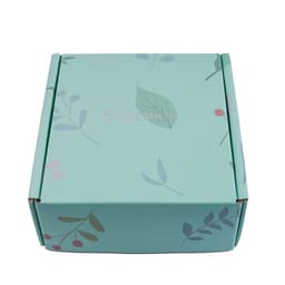 A teal packaging box with floral designs in pink and green. It has a logo on the surface.