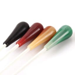 A set of four colourful resin conductor batons in black, red, amber, and green, with white shafts.
