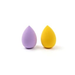 Two beauty eggs in purple and yellow, with a smooth finish, displayed side by side. Each has a rounded shape.