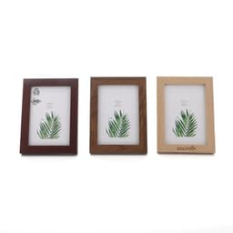 Three wooden picture frames in dark brown, medium brown, and light wood, each displaying a leaf design.