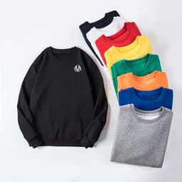 A black crewneck sweatshirt alongside eight other sweatshirts in various colours: white, red, yellow, green, blue, and grey, all stacked.