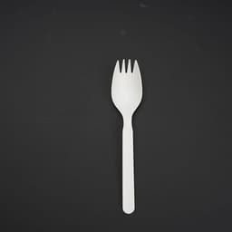 A white disposable spork on a black background, featuring a combination of spoon and fork designs.