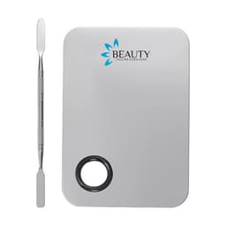 A stainless steel makeup palette set in silver, featuring a logo and a spatula for application.