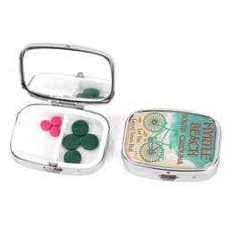 A portable metal pill box with a mirror, featuring green and pink pills, in a shiny silver finish.