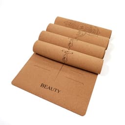 A cork rubber yoga mat in a natural tan colour with engraved designs and the word "BEAUTY" on it. It has a logo.
