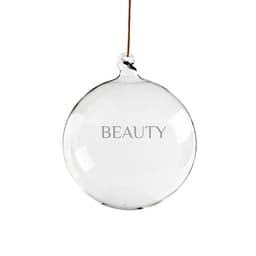A clear, round glass pendant decoration ball with a brown string for hanging, displaying the word "BEAUTY."