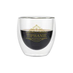 A double wall glass cup with a clear exterior and a dark beverage inside, featuring a logo design.