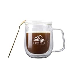 A glass mug with a lid, featuring a double-layer design and a handle, filled with coffee, alongside a spoon.