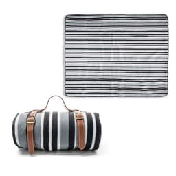 A fleece picnic blanket in black and white stripes, rolled up with a leather strap for easy carrying.
