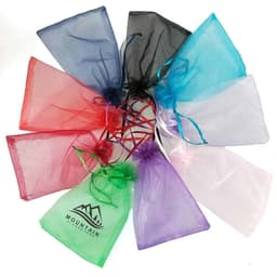 A collection of organza gift bags in various colours, including red, blue, green, white, and black, featuring drawstring closures and branding.
