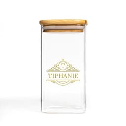 A clear high borosilicate glass storage tank with a wooden lid and decorative logo design.