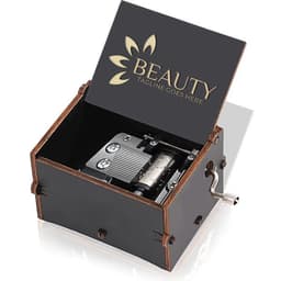 A wooden music box with a hand crank, featuring a dark exterior and decorative lid with a logo.