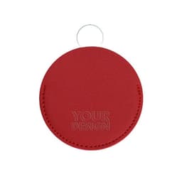 A round cosmetic mirror with a red PU leather cover, featuring a keyring and a logo or branding.
