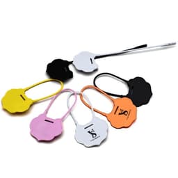 A collection of plastic tamper security seals in various colours including yellow, pink, black, orange, and white, arranged together.