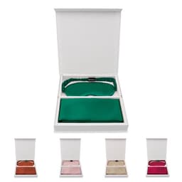 A gift box containing a green silk eye mask and three additional silk eye masks in various colours.