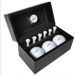 A golf ball set featuring three white golf balls and six white tees, housed in a black leather box with a logo.
