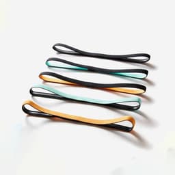 A set of custom silicone sports headbands in black with orange and mint accents, featuring a logo.