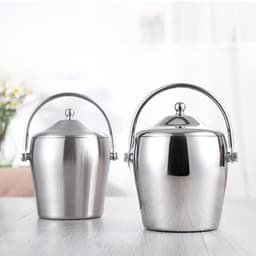 Two stainless steel ice buckets with lids, featuring polished finishes and metal handles, set on a wooden surface.