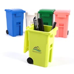 A vibrant green trash can pen holder filled with pens, surrounded by blue, white, pink, and red similar holders.
