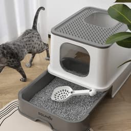 A foldable plastic cat litter box in white and grey with a scoop, featuring a vented top and a removable tray.