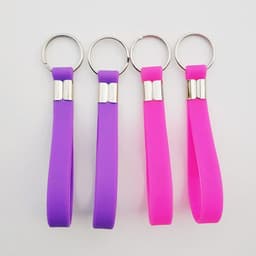 A set of silicone keychain wristbands in purple and pink, featuring metal keyring attachments.