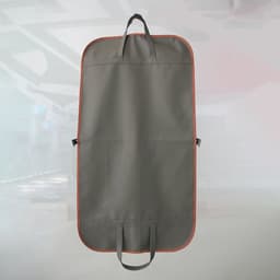 A hanging garment bag in grey with orange trim, featuring handles and a logo.