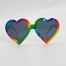 Rainbow heart-shaped sunglasses with multicoloured frames and dark lenses. The frames feature vibrant stripes.