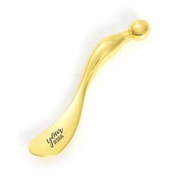 A gold S-shaped facial massage stick with a rounded end, featuring a logo on one side.
