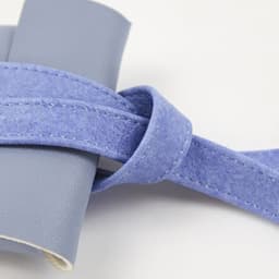 A PVC leather glasses storage bag in a soft lavender hue, featuring a strap for easy carrying.