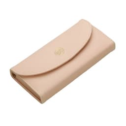 A pale pink wallet with a textured finish and a gold logo on the front.